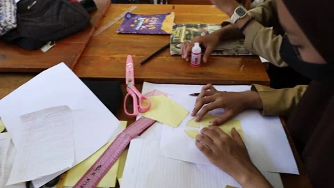 The students in groups learn to make clothing design patterns in the classroom. Stock Footage 243626607