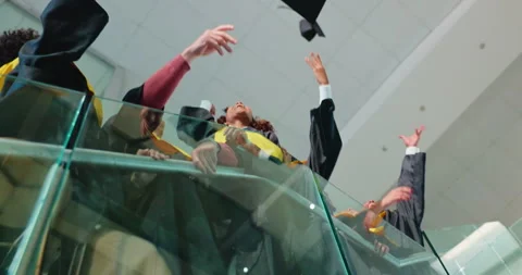 Students, hands and throw with graduation cap, celebration and success with Stock Footage 312314526