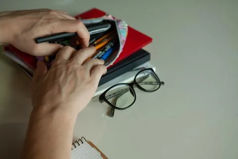The student's hands dig in a pencil case Stock Photos