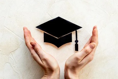 Students hands with graduation hat or academic cap paper cut Stock Photos