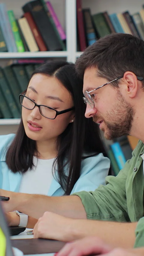 Students have discussion, use laptop, prepare for exams together, helping Stock Footage 345144545