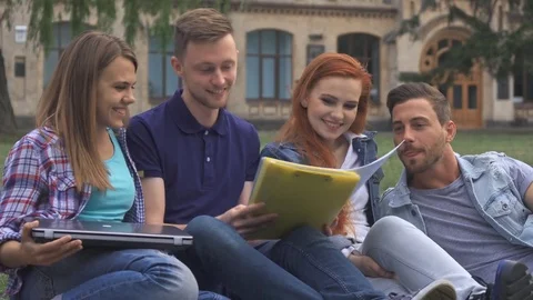 Students have fun on the lawn on campus Stock Footage 79783249