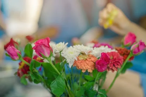 Students help each other to create a flowers tray with pedestal  for The Teac Stock Photos