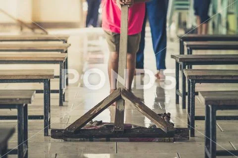 Students help to rub the floor in the canteen Stock Photos