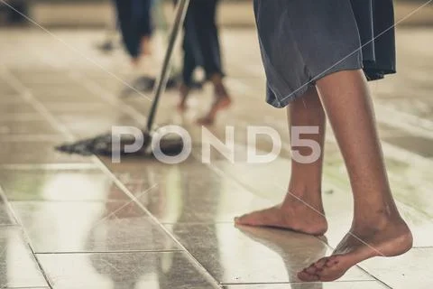 Students help to rub the floor in the canteen Stock Photos