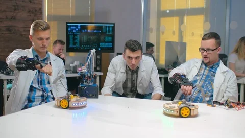 Students holding robots fighting Stock Footage 97636820