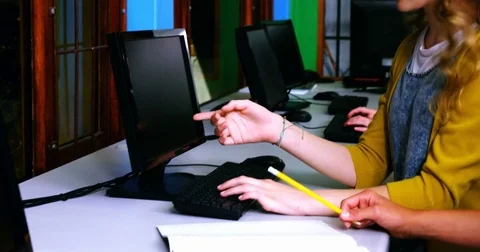 Students interacting while using computer in classroom 스톡 동영상 74620716