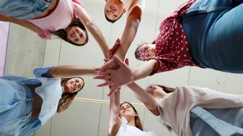 Students joining hands in teamwork and collaboration Stock Footage 308653494