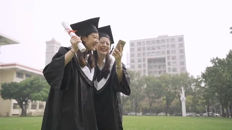 Students jumping hold diploma scroll on meadow 库存影片 108430131