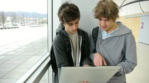 Students with laptop computer in school lounge Stock Footage 18194992
