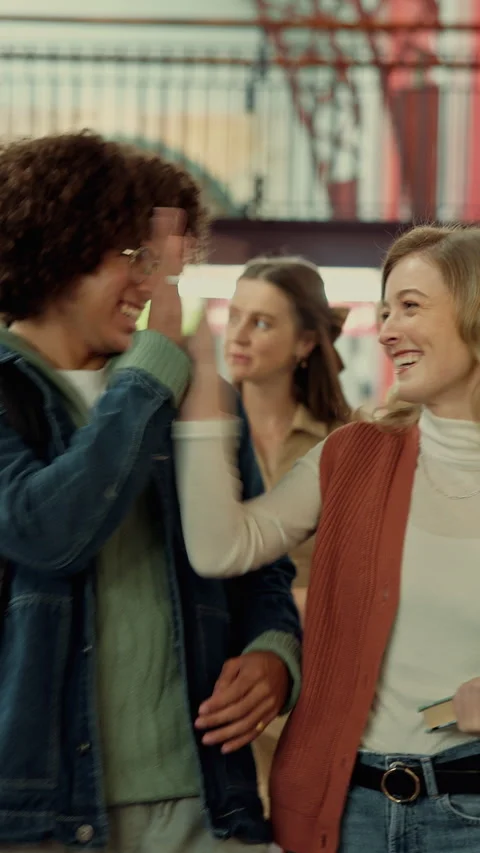 Students, laugh and high five in college with funny conversation, education Stock Footage 335804208