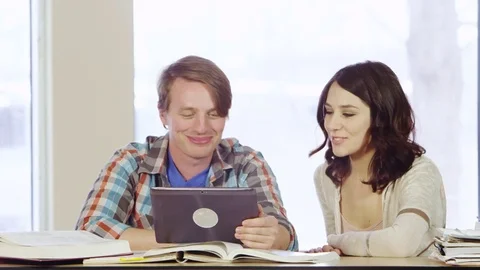 Students laughing and chatting using tablet Stock Footage 80268407