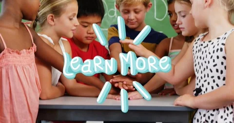 Students leaning around table in classroom, Learn More graphic appearing, hands Stock Footage 330032971