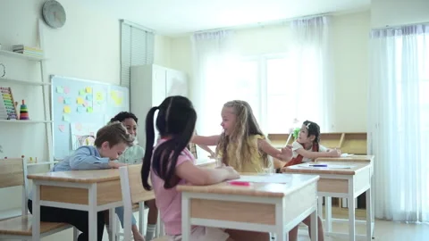Students learn and study in a classroom of school where youngsters sit and play Stock Footage 283011736
