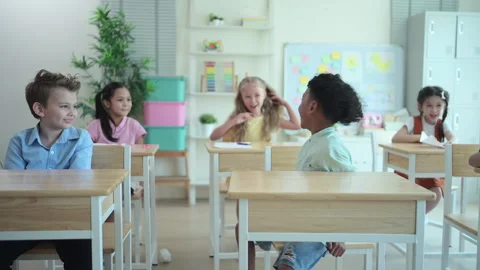 Students learn and study in a classroom of school where youngsters sit and play Stock Footage 283051174