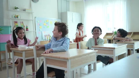 Students learn and study in a classroom of school where youngsters sit and play Stock Footage 283059691