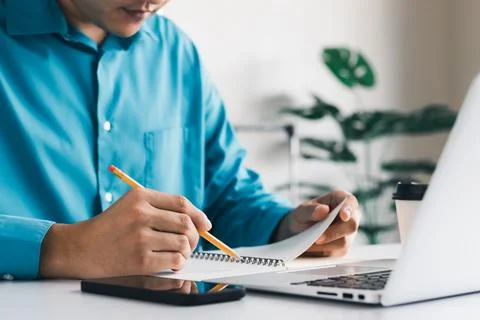 Students learn online classes using a laptop computer and writing notebooks a Stock Photos