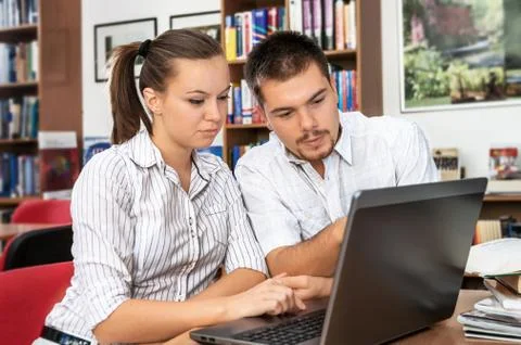 Students learn online in a library Stock Photos
