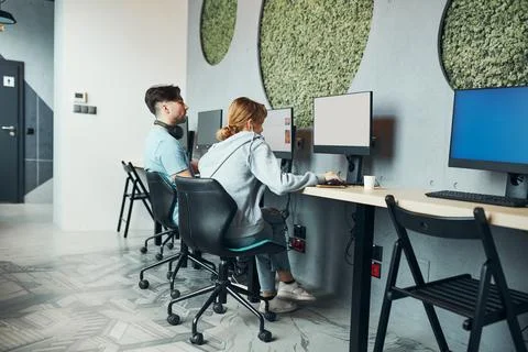Students learning in computer classroom. Young man preparing for test on co.. Stock Photos