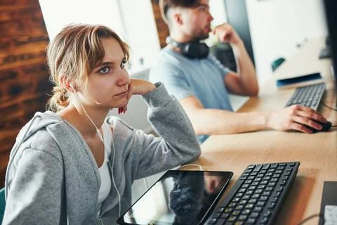 Students learning in computer classroom. Young man preparing for test on co.. Stock Photos