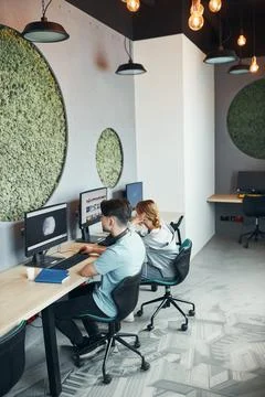Students learning in computer classroom. Young man preparing for test on co.. Fotos Stock
