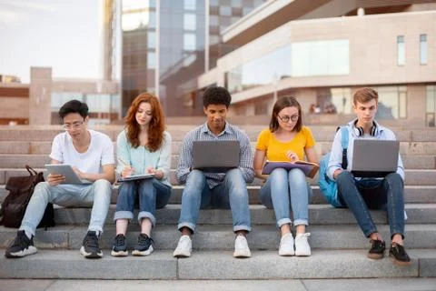 Students Learning Preparing For End-Of-Semester Exams Sitting On Steps Outside Stock Photos