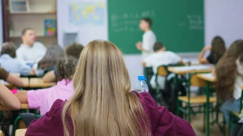 Students listening to a teacher during a lesson in a modern classroom setti.. Stock Footage 345668755