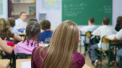 Students listening to a teacher during a lesson in a modern classroom setti.. Stock Footage 345669288