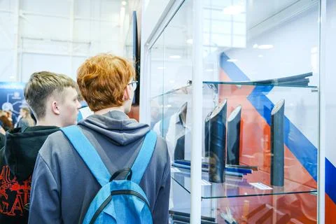 Students looking at cable production samples in glass showcase at industrial Stock Photos