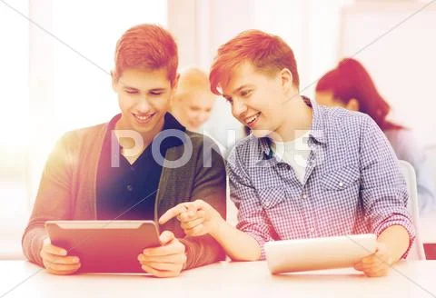 Students looking at tablet pc in lecture at school Stock Photos