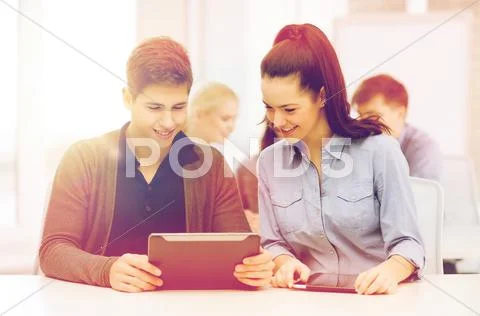 Students looking at tablet pc in lecture at school Stock Photos