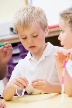 Students in math class using counting beads (selective focus) Stock Photos
