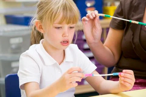Students in math class using counting beads (selective focus) Stock Photos