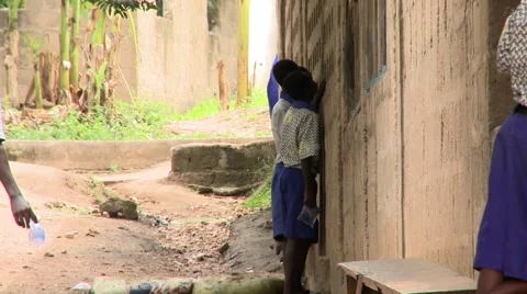 STUDENTS MILLING ABOUT WITH PLASTIC WATER SACHETS Stock Footage 60116074