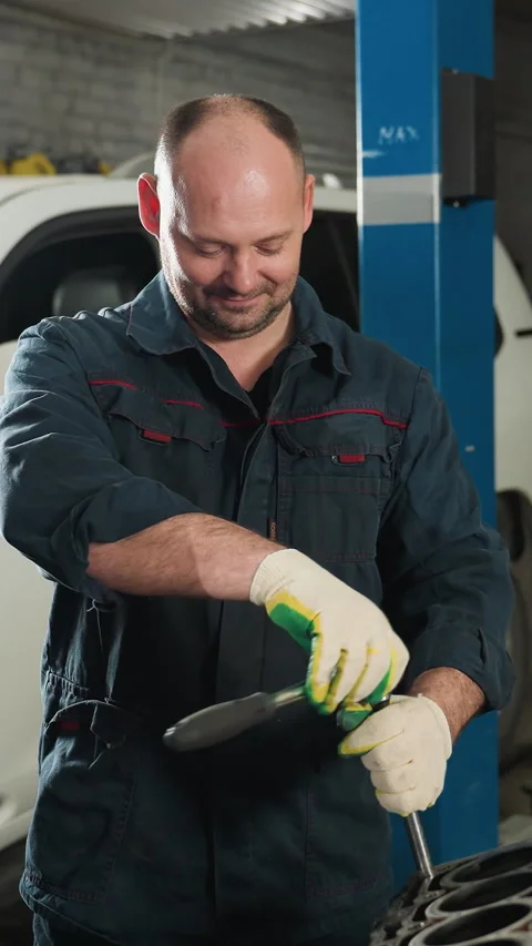 Students Observe Mechanic Demonstrating Spanner Use on Car Engine Stock Footage 318262504