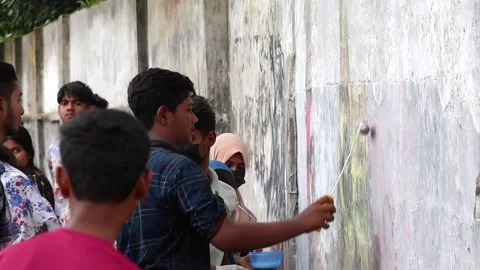 Students paint graffiti on wall for memory of those killed in quota reform. Stock Footage 317867802