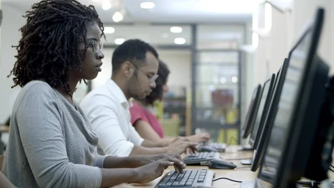 Students passing exams by computers in class Stock Footage 116775748