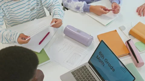 Students Passing Worksheets to Teacher i... | Stock Video | Pond5
