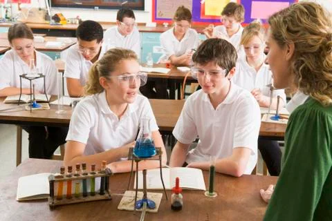 Students performing science experiments in classroom Stock Photos