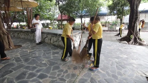 Students of Pieamsuwan school in Buddhist Camp, Students are sweeping the floor Stock Footage