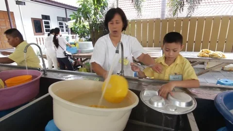 Students of Pieamsuwan school in Buddhist Camp, Students are washing dishes Stock Footage 76995696