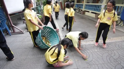 Students of Pieamsuwan school in Buddhist Camp, Students are sweeping the floor Stock Footage