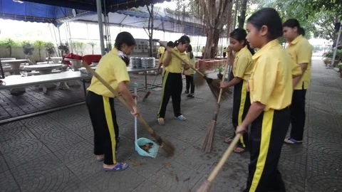 Students of Pieamsuwan school in Buddhist Camp, Students are sweeping the floor Stock Footage 76995944