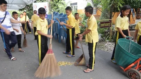 Students of Pieamsuwan school in Buddhist Camp, Students are sweeping the floor Stock Footage 76995948