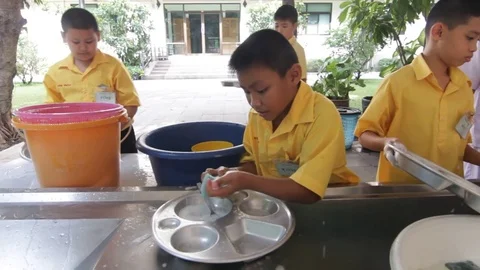 Students of Pieamsuwan school in Buddhist Camp, Students are washing dishes Stock Footage 76996059