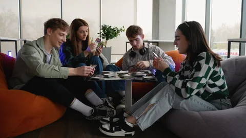 Students playing board games in modern lounge area Stock Footage 313245614