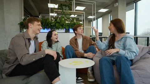 Students playing guessing game with sticky notes on foreheads Stock Footage 313248040