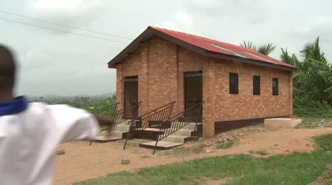 STUDENTS PLAYING SOCCER IN FRONT OF A NEW SANITATION FACILITY Stock Footage 60116056
