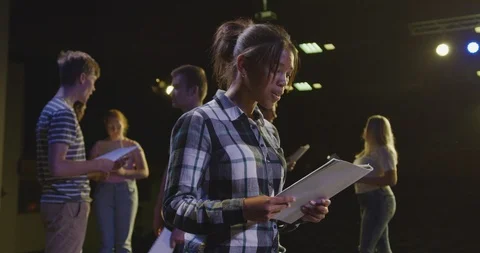 Students preparing before a high school performance in an empty school theater Stock Footage 124992538