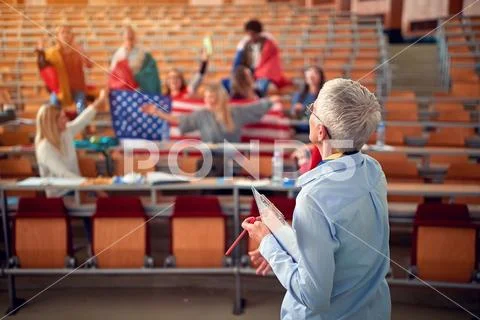 Students present country with flag on university campus. Stock Photos